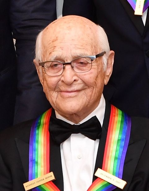 Norman Lear  poses a picture in a black suit.